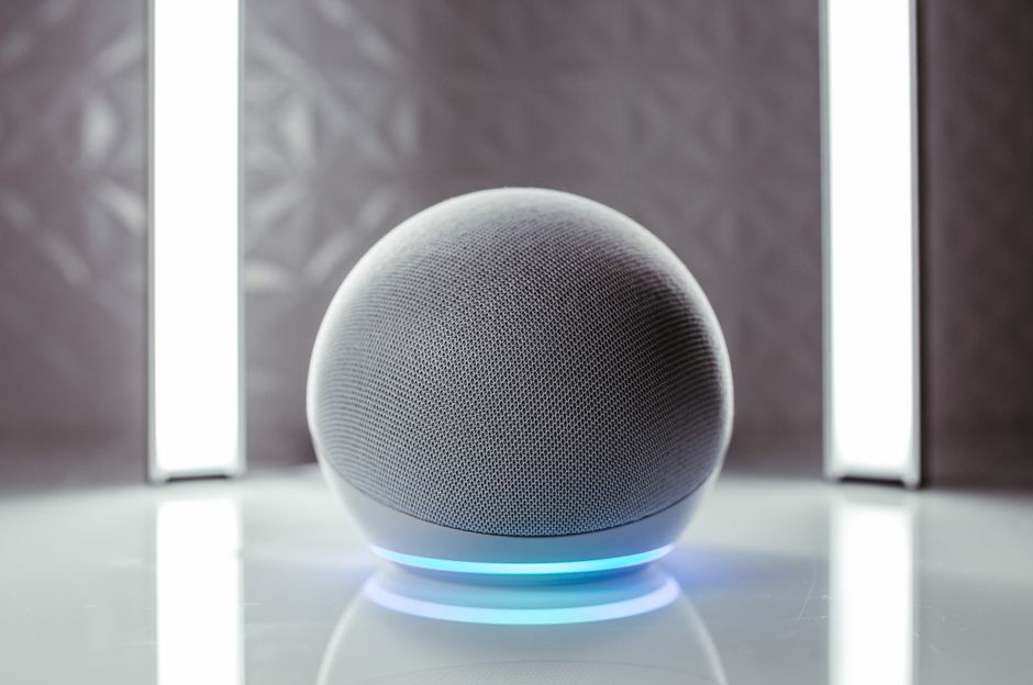 Close-up of a spherical smart speaker with illuminated base, perfect for modern interiors.